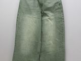 a close up of a pair of green jeans hanging on a hanger