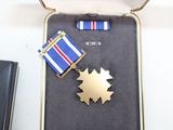 a small case with a medal and a medal on it
