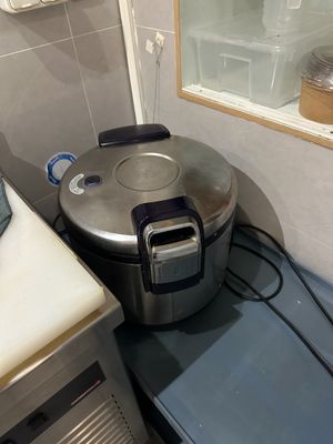 a small kitchen with a stove, sink, and toaster on the counter