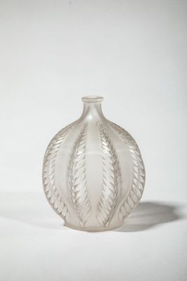 a clear glass vase sitting on a white surface