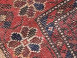 a close up of a red and blue oriental rug