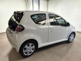 a picture of a small white car parked in a garage