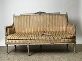 a couch that has a pillow on it in a room