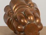 a bronze sculpture of a flower on a table