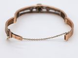 a close up of a bracelet on a white surface