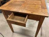 an old wooden desk with a drawer on top of it