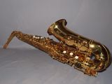 an image of a saxophone sitting on top of a white surface