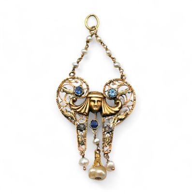 a close up of a gold and blue necklace with pearls