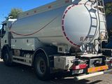 a white tanker truck that is parked in the parking lot