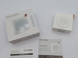 an image of a white box containing a speaker and a charger