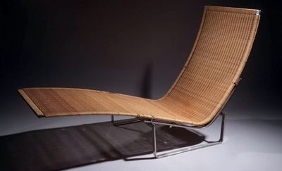 an image of a modern lounge chair in a dark room
