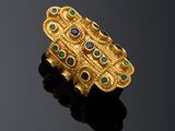 an image of a gold ring with blue and green stones