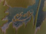 a close up of a green vase with a name on it