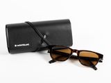 a pair of sunglasses and a case on a white surface