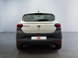 the rear end of a white and black car in a white room