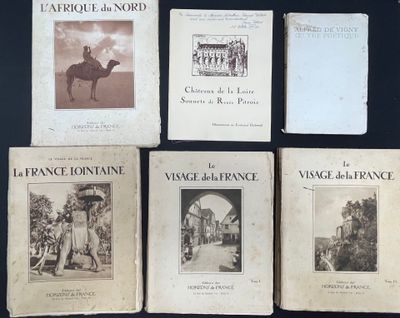 four books on a table with a picture of a man riding a camel
