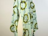 an image of a green and yellow scarf on a mannequin mannequin