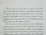 an open book with a black ink writing on it