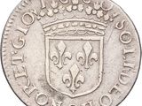 a close up of a silver coin with a crown on it