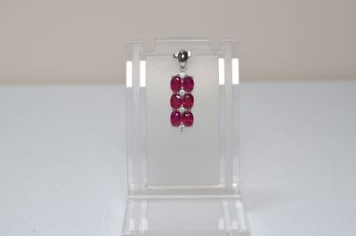 a small display case with a pair of earrings in it