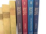 several books are lined up in a row on a white surface