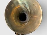 a brass vase with a black hole in the middle