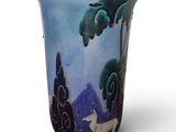 a blue vase with a picture of a deer and trees on it