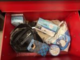 a red box filled with assorted items on the floor