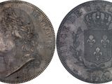a close up of two silver coins with a crown on them