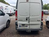a white van parked in a parking lot with other cars