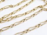 a close up of a gold chain on a white surface