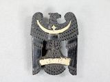 an image of a black and gold eagle brooch