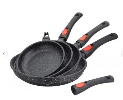 a close up of three pans and a spatula on a white background