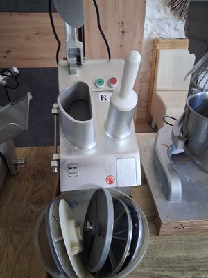 a blender and a mixer sitting on a wooden table