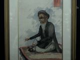 tableau représentant un vieil homme assis sur un tapis, une pipe à la main