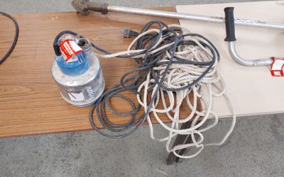 a table with a bunch of wires and a water bottle