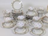 a lot of plates and cups and saucers on the table