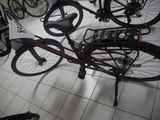many bikes that are sitting on the floor in a room