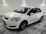 La Toyota Yaris blanche est garée dans une salle blanche.