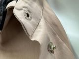 a close up of a shirt with a button on it