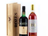 two bottles of wine and a wooden box on a white background