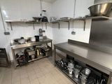 a large kitchen with a lot of stainless steel counter tops
