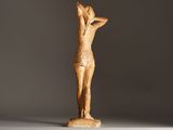 an image of a wooden statue of a woman holding her hands up