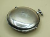 a silver pocket watch sitting on a white surface