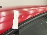a red car with a remote control attached to it