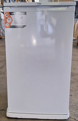 an image of a white refrigerator in a warehouse