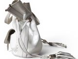a white purse with a pair of scissors on it