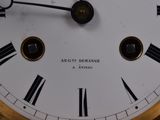 a close up of a clock with roman numerals on it