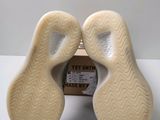 the soles of a pair of shoes are shown in front of a box