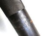 a close up of a metal object on a white surface